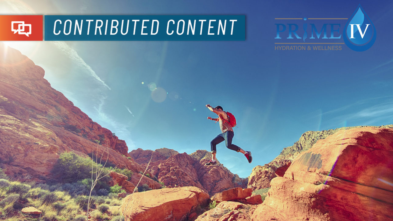 a person jumping between two large rocks in the desert with the text "contributed content" overlaid