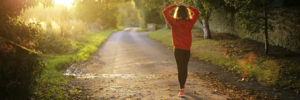 woman walking down a dirt road