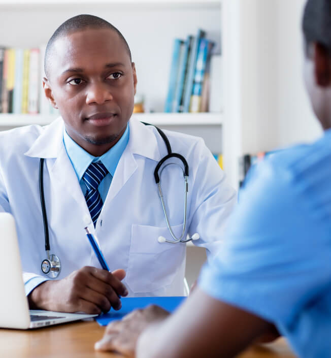 male african american doctor in consultation with young patient