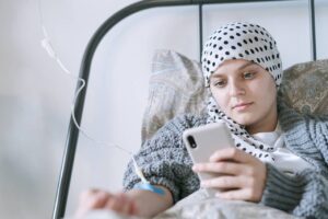 Girl laying in bed with an IV