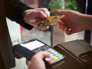 People using a credit card and payment terminal for payment