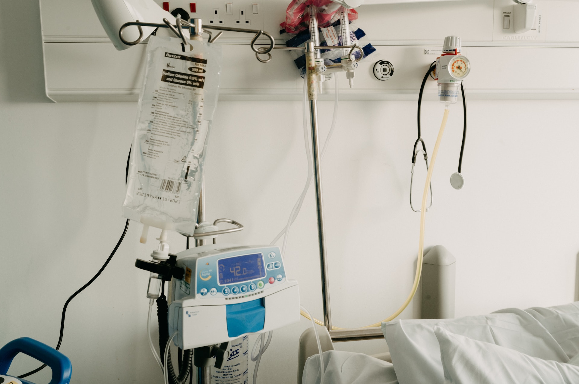 an IV bag hanging over a hospital bed