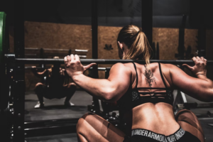 Woman with muscles lifting a barbell