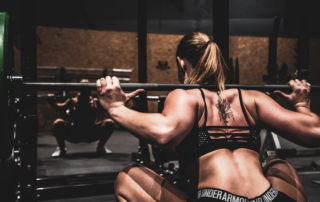 Woman with muscles lifting a barbell
