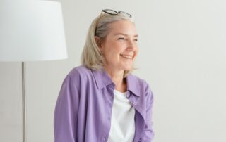 smiling woman after an anti-aging peptide therapy session