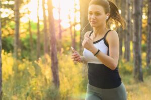 A Woman Running on a Trail