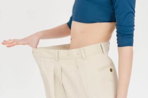 Person holding out oversized pants