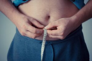 Person measuring their stomach