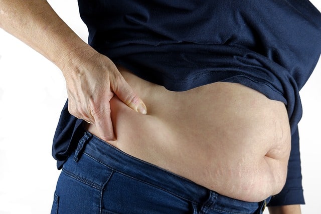 Women pressing their stomach fat