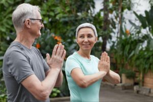 Two older people doing yoga