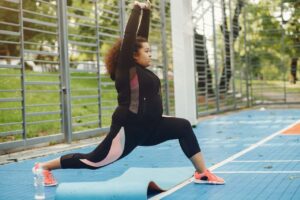 woman stretching before exercise after an AOD 9604 injection