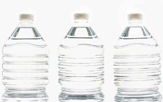 three clear water bottles