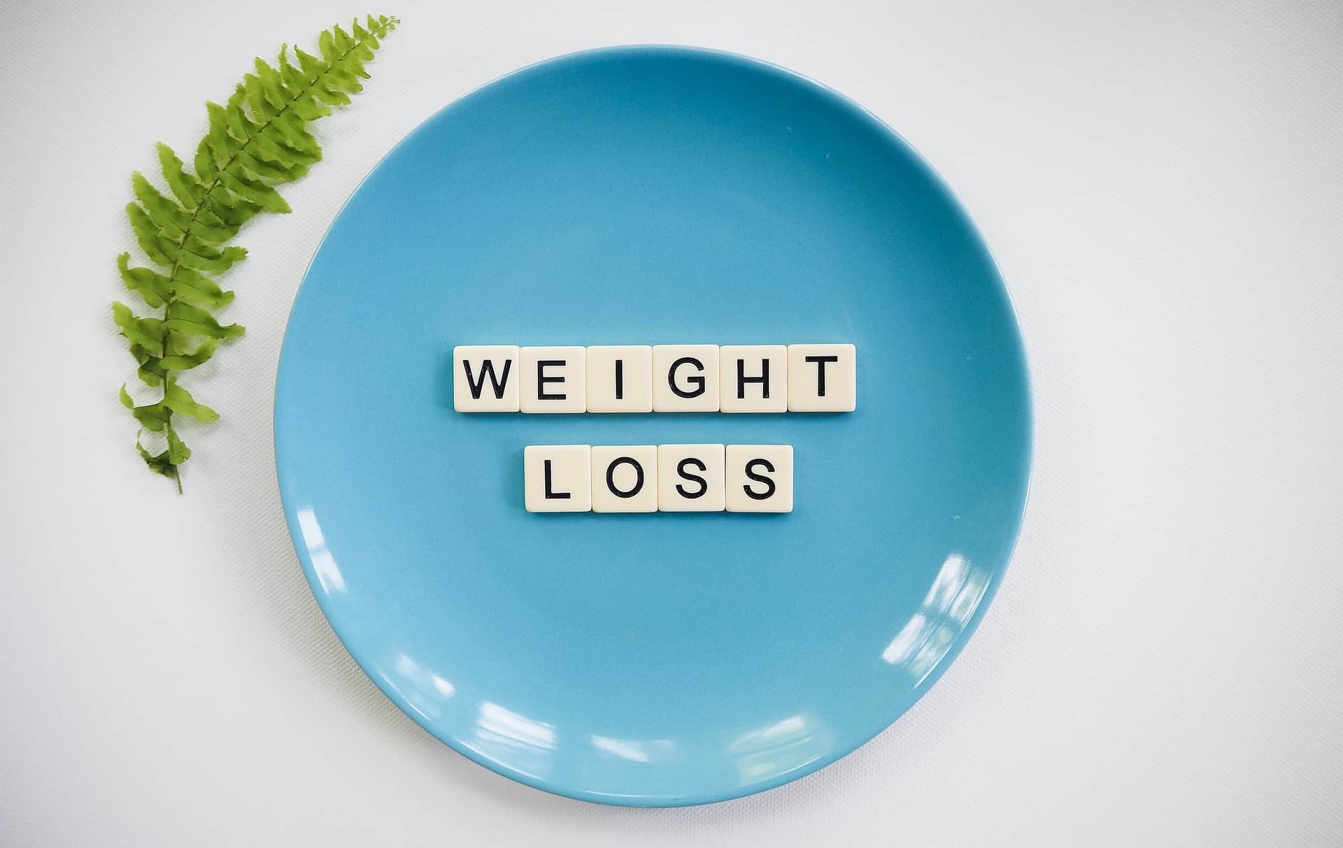 Blue Plate With Weight Loss in Spelled in Tiles