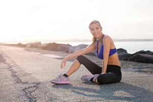 Fit-looking woman sitting on a road