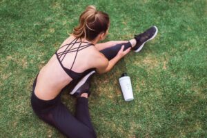 woman-stretching-in-grass