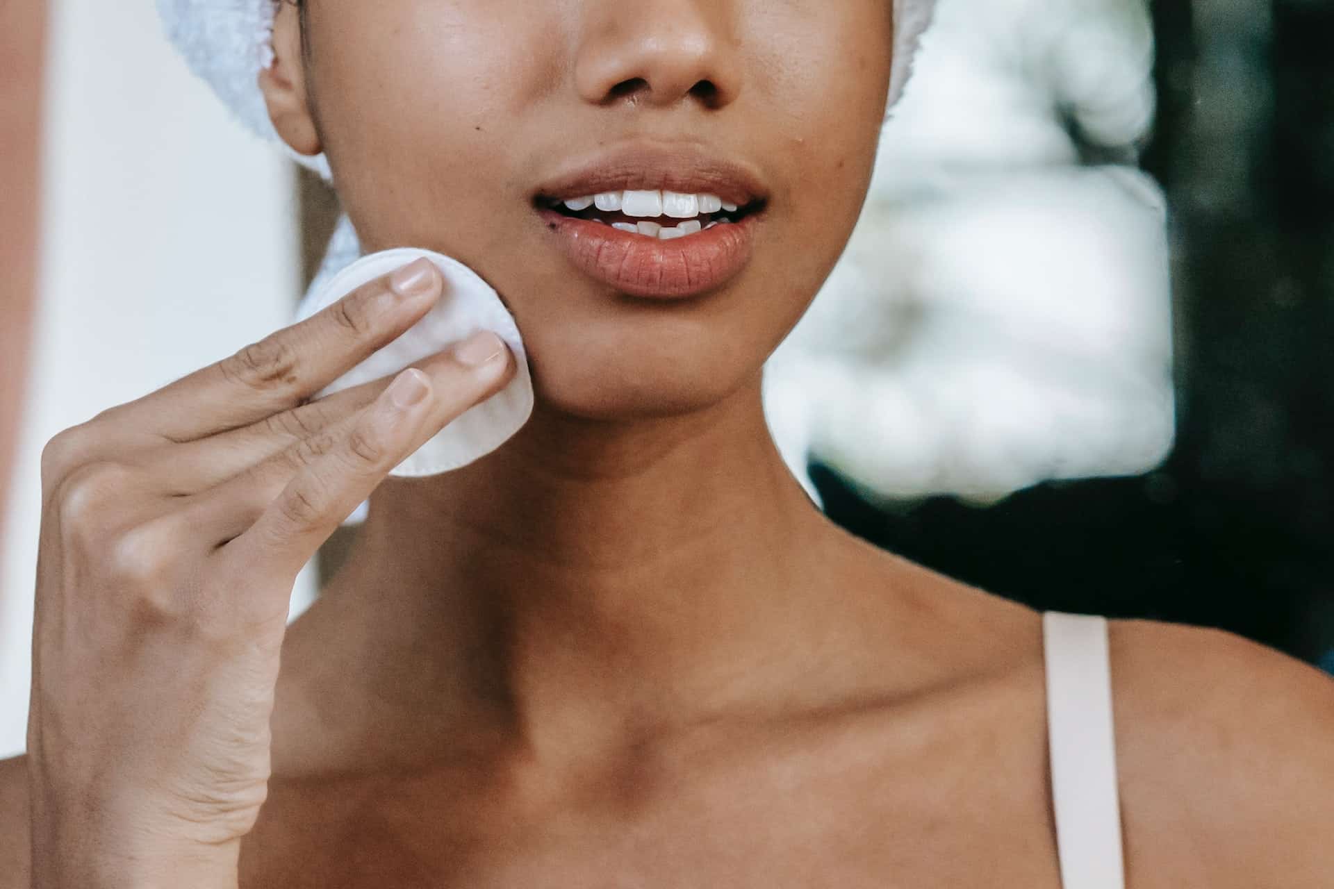 Woman using a cotton pad on her face