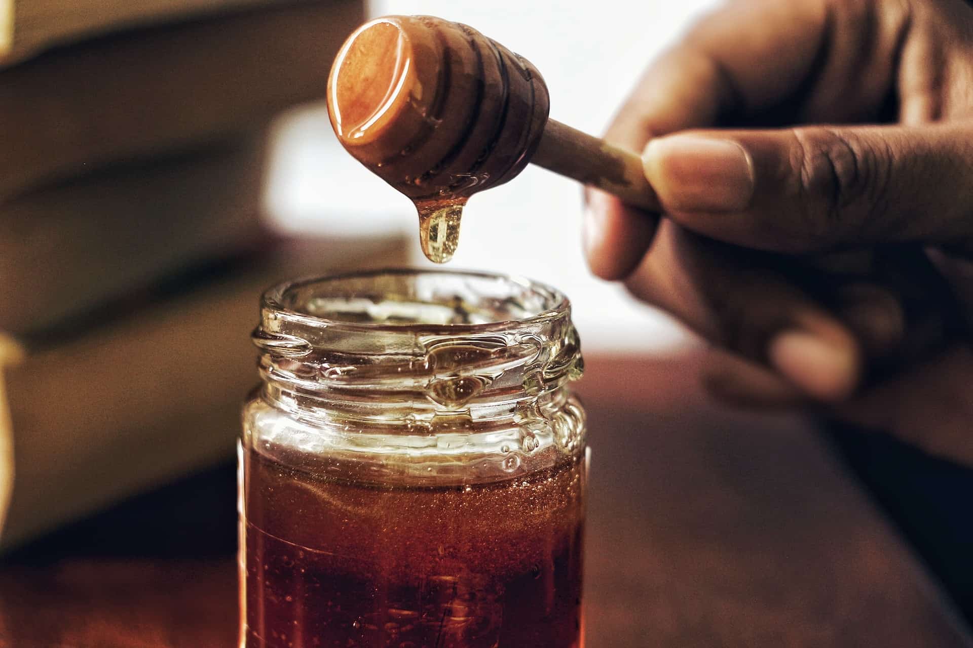 Honey dripping from a honey spoon