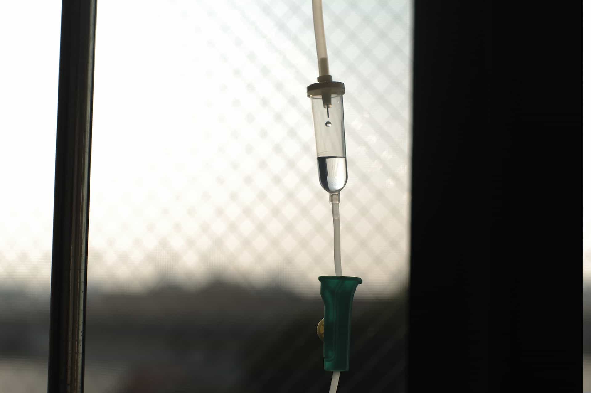An IV drip tube by a window