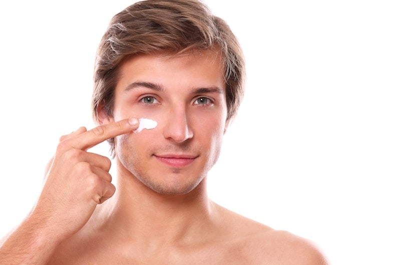 Man applying cream to his face