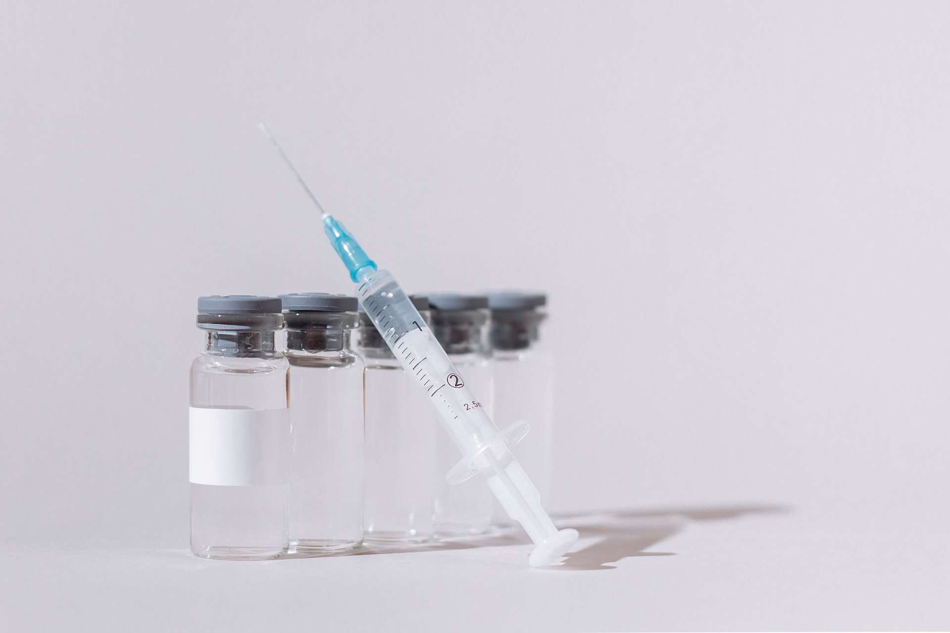 a syringe and peptide vials