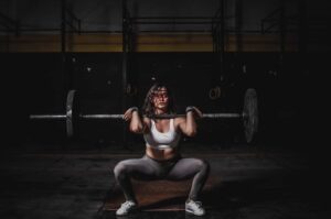 a woman squatting with a barbell