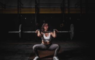 a woman squatting with a barbell