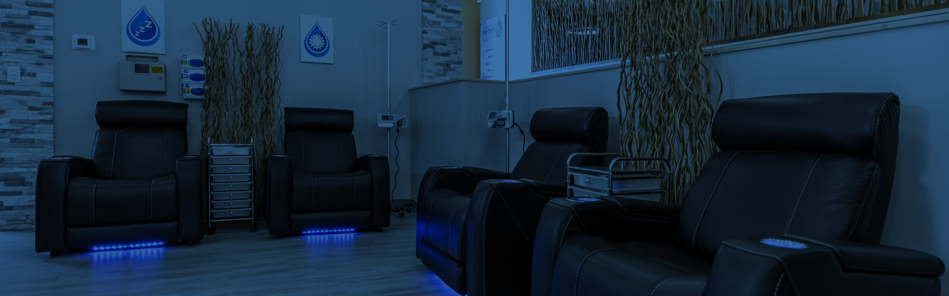 Man in a massage chair receiving an IV treatmentsMassage chairs in a wellness clinic prepared for IV treatments