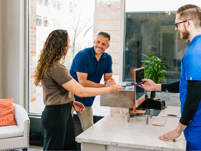 Man and Woman couple at the front desk talking about what they will be doing for their health and wellness