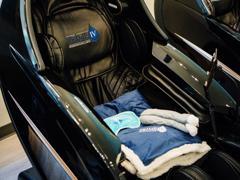 Zero-gravity massage chair with Prime IV blankets and socks for relaxation